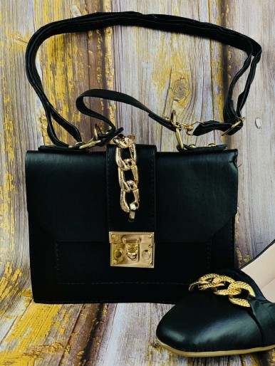 A black bag and shoes with a decorative knot