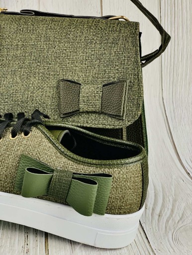 A bag and sneakers in a light and dark green color with a decorative flower