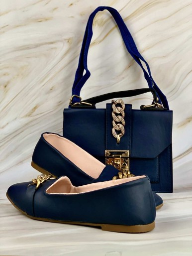 Navy bag and shoes with golden rings