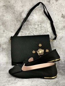 Bag and shoes in black fabric with a decorative metal flower