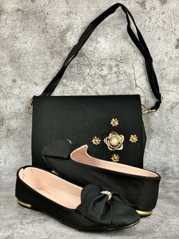 Bag and shoes in black fabric with a decorative metal flower