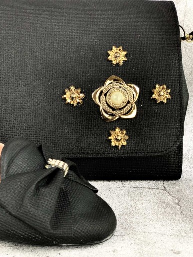 Bag and shoes in black fabric with a decorative metal flower