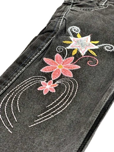 Girls' black jeans with a floral pattern