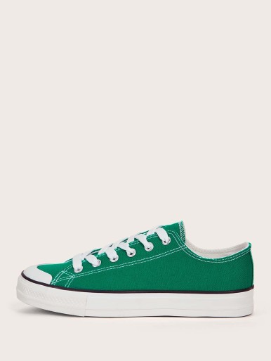 حذاء رياضي أخضر مع نعل أبيض وأربطة