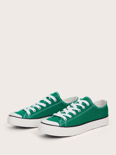 حذاء رياضي أخضر مع نعل أبيض وأربطة