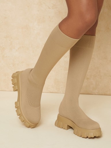 Women's high boots with a wide sole and a knitted face
