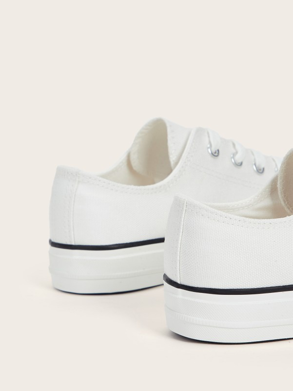 White sneakers with white sole and laces