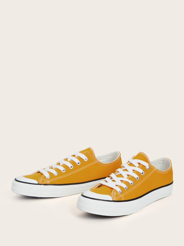 Cumin yellow sports shoes with white sole and laces